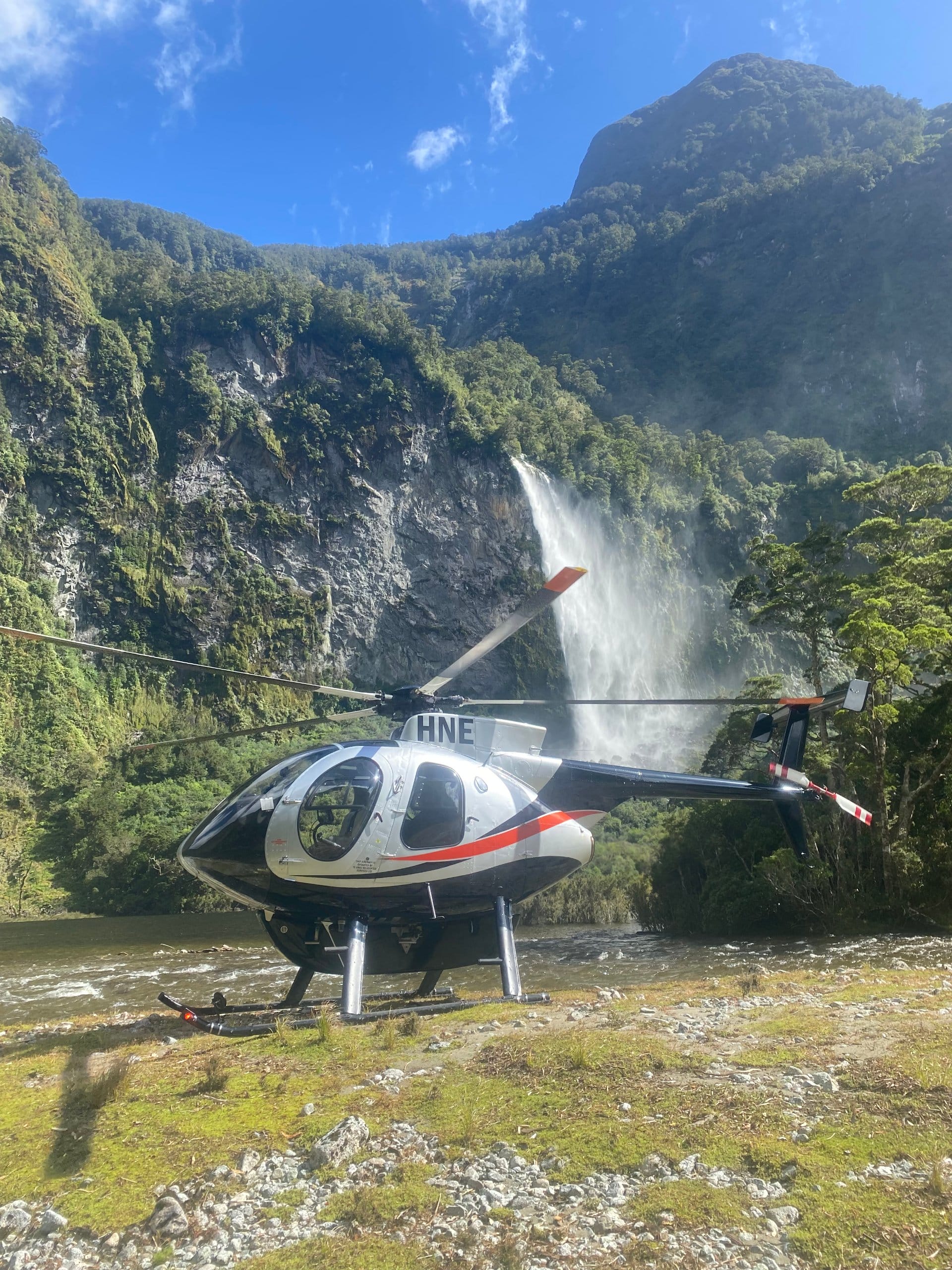 ZK-HNE Helicopter with waterfall in the background